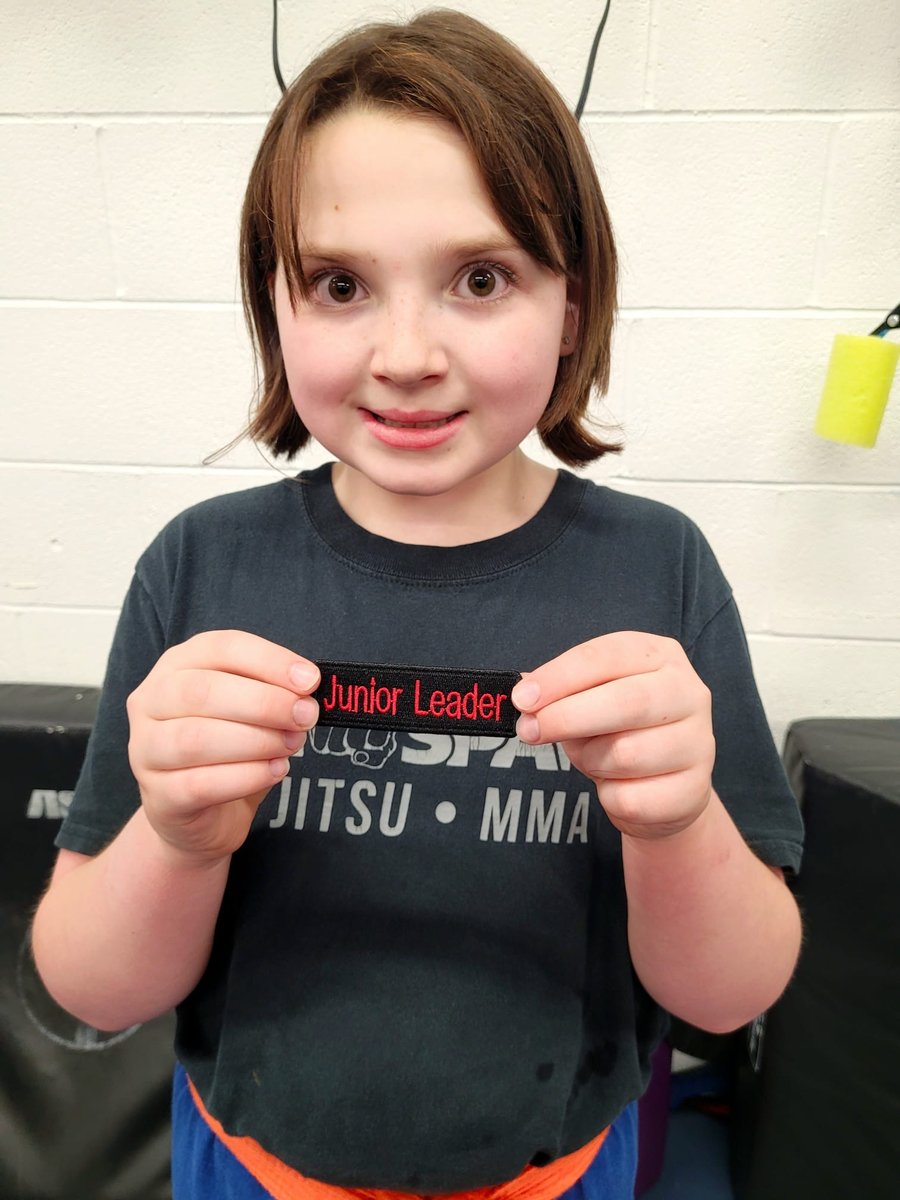 Alison holding her Junior Leader badge